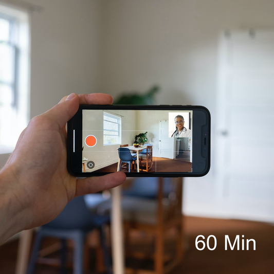 Person holding a cell phone on a video call with a doctor | AskSAMIE 60 min virtual assessment
